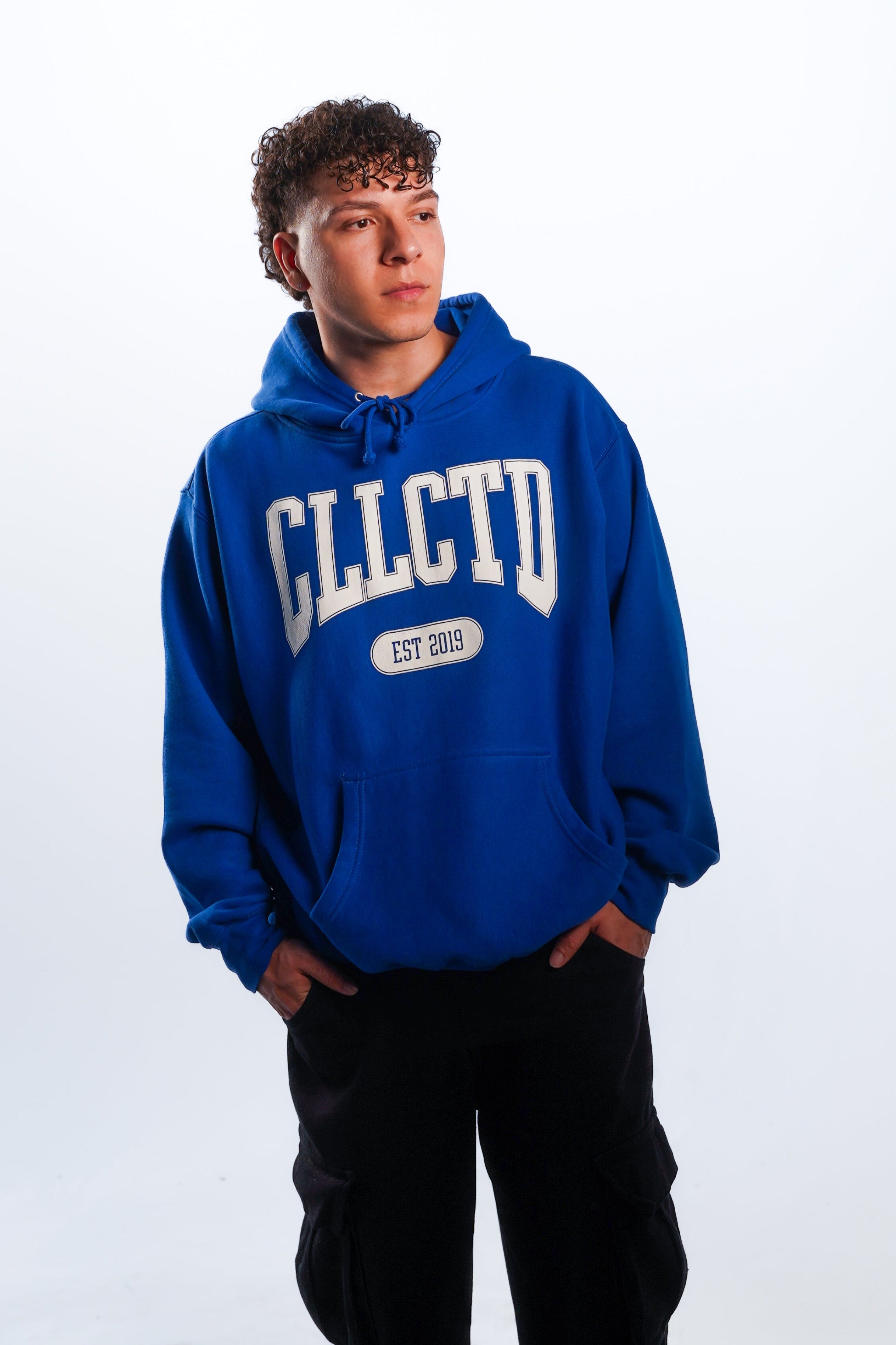 Person wearing a blue hoodie with 'CLLCTD' text on a white background